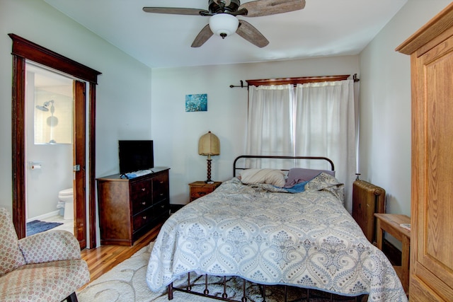 924 6th St W, Wabasha, MN 55981 - bedroom with wood finished floors, radiator heating unit, ceiling fan, and connected bathroom