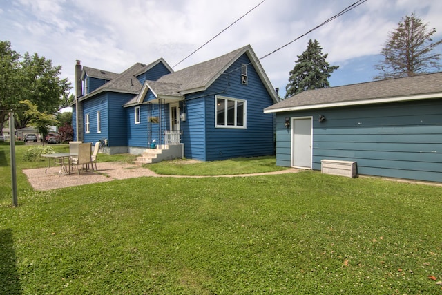 924 6th St W, Wabasha, MN 55981 - rear view of property with a yard, a patio, and a shingled roof