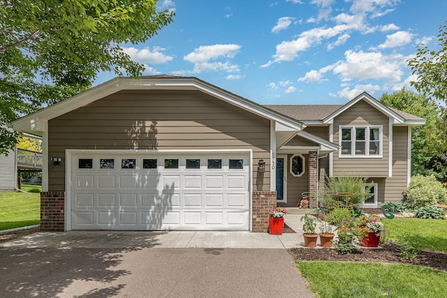 5750 Lone Oak Dr, Savage, MN 55378 - view of front facade featuring driveway, an attached garage, and brick siding