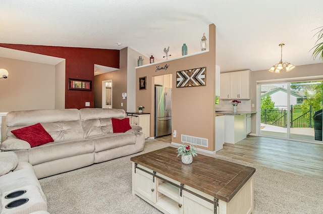 5750 Lone Oak Dr, Savage, MN 55378 - living room featuring vaulted ceiling, light colored carpet, and a chandelier