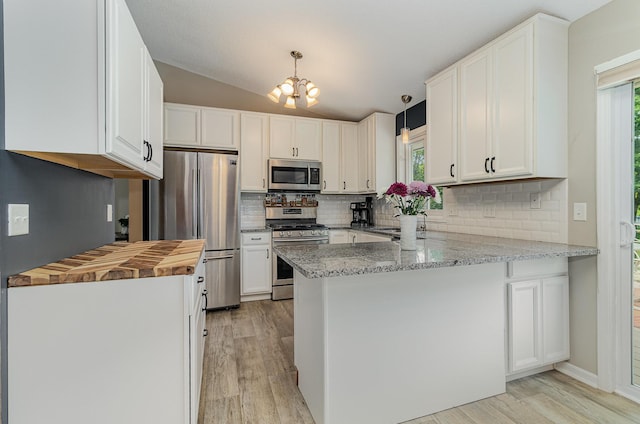 5750 Lone Oak Dr, Savage, MN 55378 - kitchen featuring stainless steel appliances, a peninsula, butcher block countertops, light wood-type flooring, and decorative backsplash