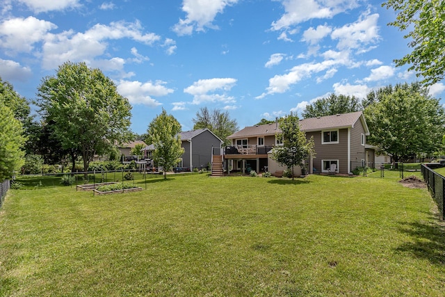 5750 Lone Oak Dr, Savage, MN 55378 - fenced backyard featuring stairway, a vegetable garden, and a wooden deck