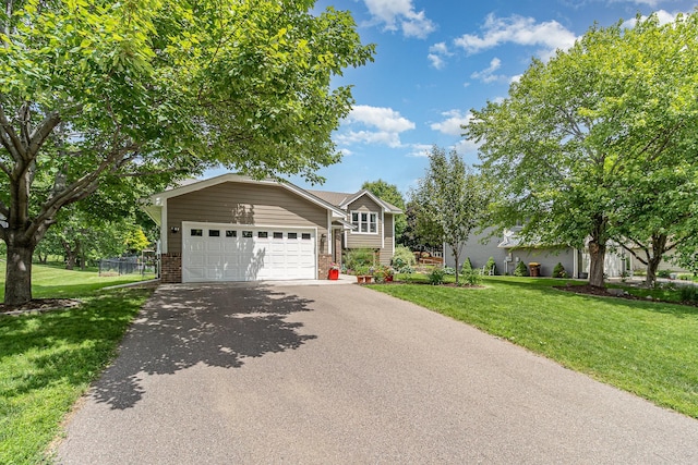 5750 Lone Oak Dr, Savage, MN 55378 - view of front facade featuring asphalt driveway, brick siding, and an attached garage