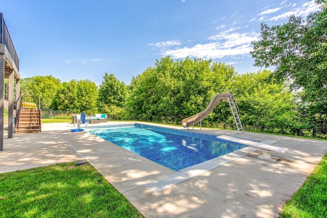 141 145th Ln NE, Ham Lake, MN 55304 - outdoor pool with stairway, a patio, a water slide, a diving board, and an outdoor hangout area