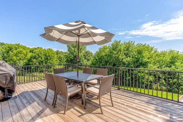 141 145th Ln NE, Ham Lake, MN 55304 - wooden terrace featuring outdoor dining space, a forest view, and a grill