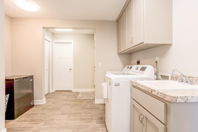141 145th Ln NE, Ham Lake, MN 55304 - laundry room with cabinet space, washer and clothes dryer, and light wood-style flooring