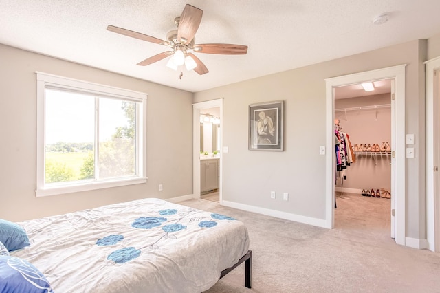 141 145th Ln NE, Ham Lake, MN 55304 - bedroom featuring light carpet, a walk in closet, and a ceiling fan
