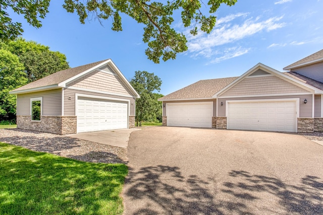 141 145th Ln NE, Ham Lake, MN 55304 - view of front of home with stone siding and an outbuilding