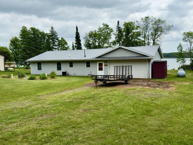 63714 Hannu Ln, Pine Lake Twp, MN 55735 - rear view of house featuring a garage, a yard, and a metal roof