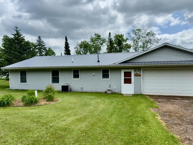 63714 Hannu Ln, Pine Lake Twp, MN 55735 - rear view of property with a yard, asphalt driveway, and a garage
