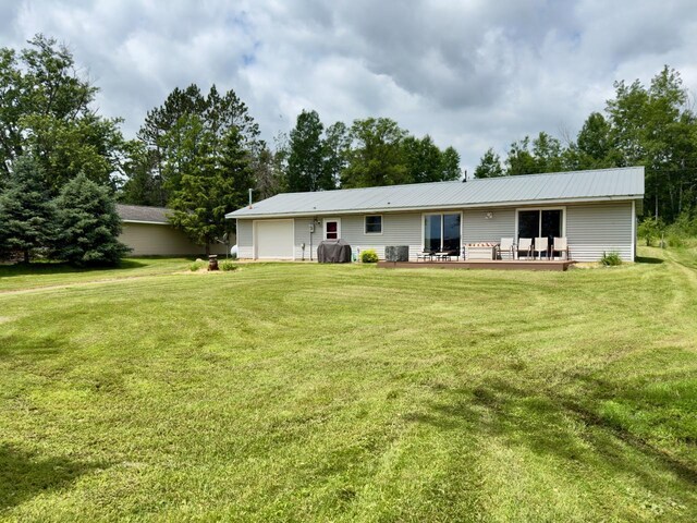 63714 Hannu Ln, Pine Lake Twp, MN 55735 - rear view of property with a garage, a lawn, a metal roof, and a patio area