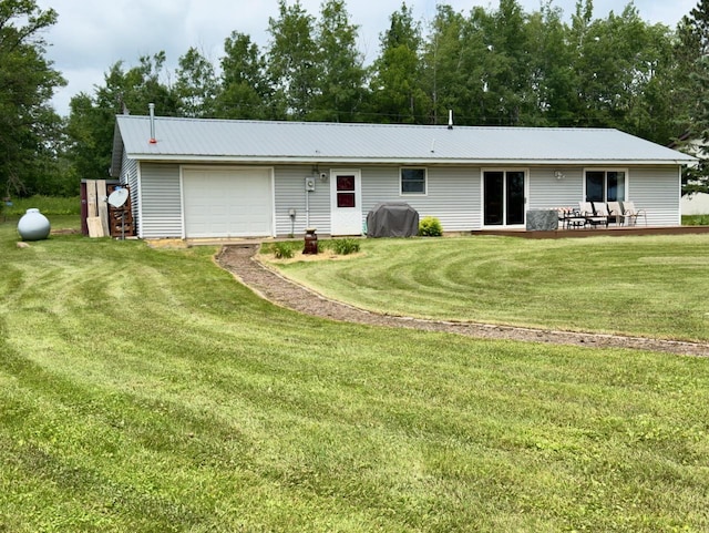 63714 Hannu Ln, Pine Lake Twp, MN 55735 - rear view of house with an attached garage, a yard, driveway, and a metal roof
