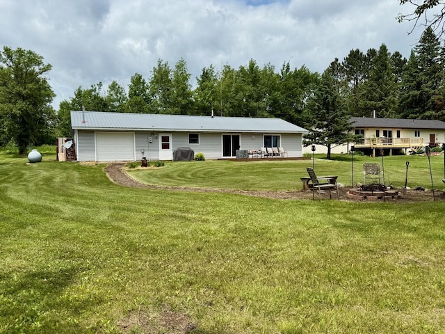 63714 Hannu Ln, Pine Lake Twp, MN 55735 - back of house featuring a garage and a lawn