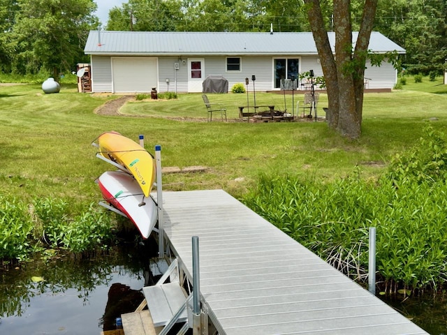 63714 Hannu Ln, Pine Lake Twp, MN 55735 - rear view of house featuring a metal roof, a yard, and a garage