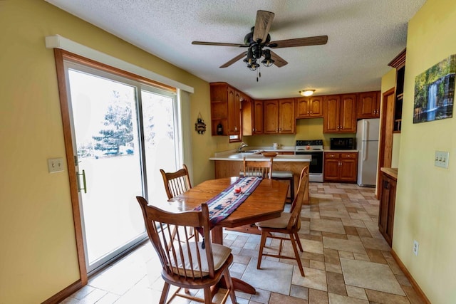 63714 Hannu Ln, Pine Lake Twp, MN 55735 - dining space featuring a textured ceiling, ceiling fan, and light stone finish floors