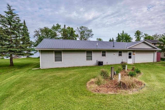 63714 Hannu Ln, Pine Lake Twp, MN 55735 - rear view of house featuring a garage, a lawn, and a metal roof