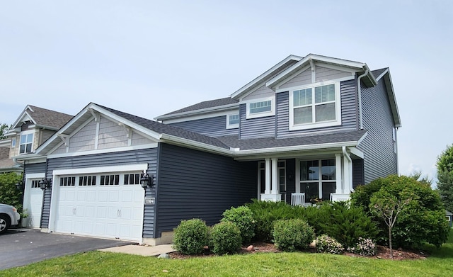 11104 4th St N, Lake Elmo, MN 55042 - view of front of house with a garage, asphalt driveway, and a porch