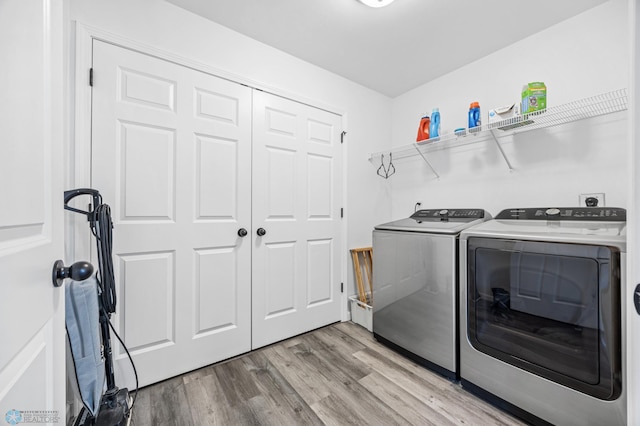1009 Highland Ln W, West Fargo, ND 58078 - washroom featuring separate washer and dryer and light wood-type flooring