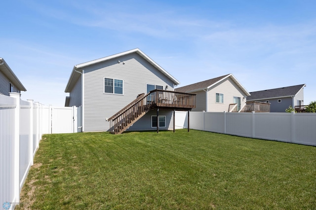 1009 Highland Ln W, West Fargo, ND 58078 - back of property with stairs, a fenced backyard, and a deck