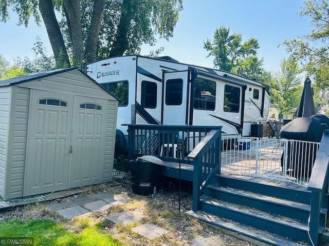 23488 Waskawood Rd # 110, Long Beach, MN 56334 - rear view of property featuring a storage unit and a wooden deck