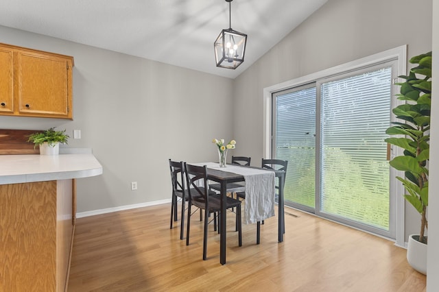 6913 174th St W, Farmington, MN 55024 - dining space with plenty of natural light, vaulted ceiling, light wood finished floors, and a chandelier