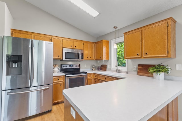 6913 174th St W, Farmington, MN 55024 - kitchen featuring stainless steel appliances, vaulted ceiling, a peninsula, light countertops, and light wood-style floors