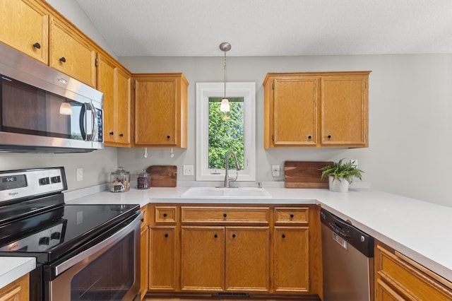 6913 174th St W, Farmington, MN 55024 - kitchen featuring appliances with stainless steel finishes, light countertops, decorative light fixtures, and brown cabinets