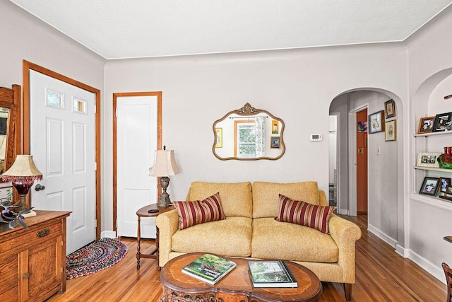 4918 Glenwood St, Duluth, MN 55804 - living room featuring arched walkways and light wood-type flooring