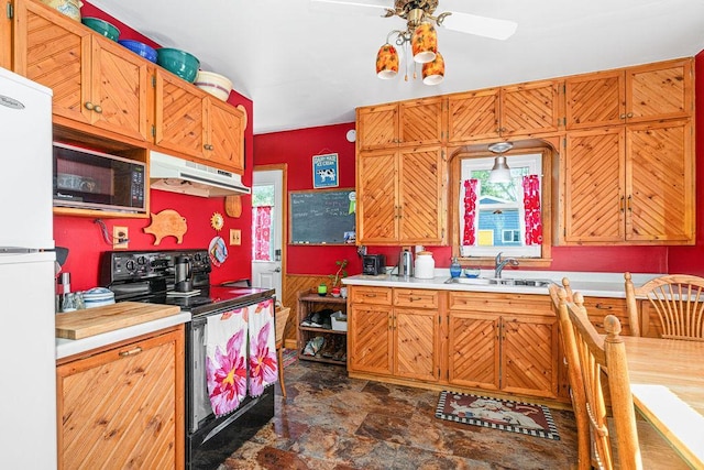 4918 Glenwood St, Duluth, MN 55804 - kitchen with black appliances, under cabinet range hood, stone finish flooring, light countertops, and a ceiling fan