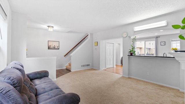 11333 Stratton Ave, Eden Prairie, MN 55344 - carpeted living area with stairway and a textured ceiling