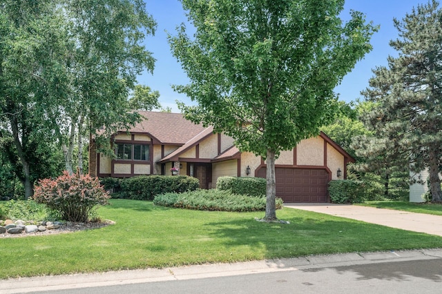 1306 Wynridge Dr, Arden Hills, MN 55112 - tudor home with a garage, stucco siding, a front lawn, and driveway