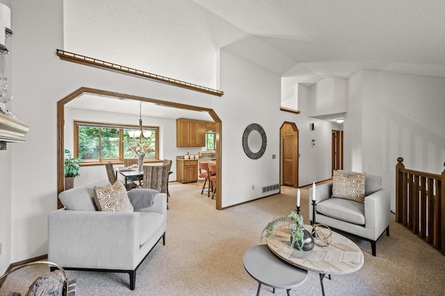 1306 Wynridge Dr, Arden Hills, MN 55112 - living area with arched walkways, light colored carpet, high vaulted ceiling, and a chandelier