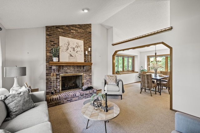 1306 Wynridge Dr, Arden Hills, MN 55112 - living room with vaulted ceiling, carpet flooring, a chandelier, and a fireplace