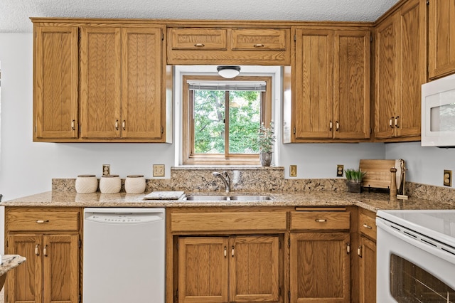 1306 Wynridge Dr, Arden Hills, MN 55112 - kitchen featuring white appliances, brown cabinetry, and light stone counters