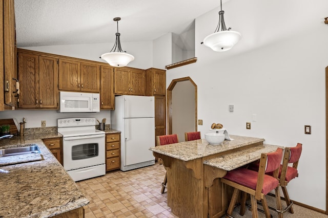 1306 Wynridge Dr, Arden Hills, MN 55112 - kitchen featuring white appliances, vaulted ceiling, brown cabinets, a breakfast bar area, and hanging light fixtures
