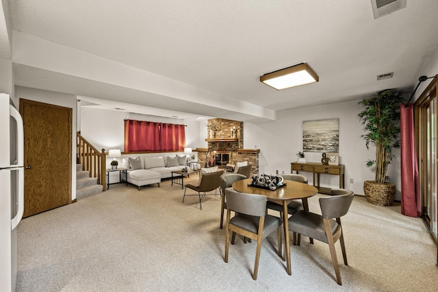 1306 Wynridge Dr, Arden Hills, MN 55112 - dining space featuring light carpet, a fireplace, and stairway