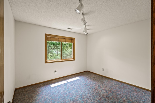 1306 Wynridge Dr, Arden Hills, MN 55112 - empty room with track lighting, carpet floors, and a textured ceiling
