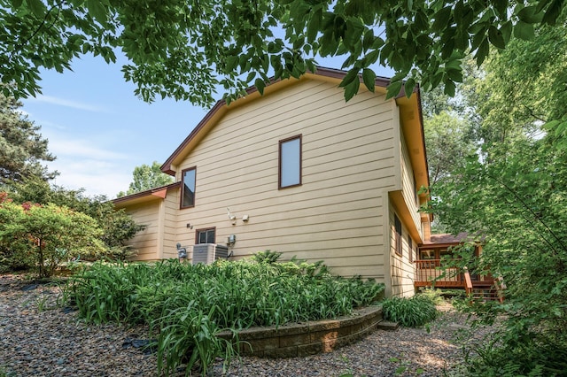 1306 Wynridge Dr, Arden Hills, MN 55112 - view of home's exterior with a wooden deck and a central AC unit