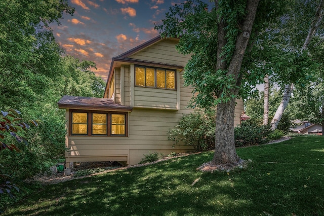 1306 Wynridge Dr, Arden Hills, MN 55112 - property exterior at dusk featuring a yard