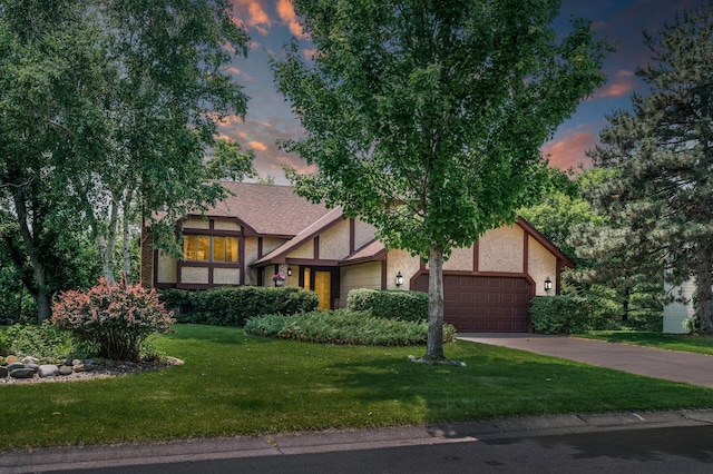 1306 Wynridge Dr, Arden Hills, MN 55112 - tudor home featuring a garage, stucco siding, a yard, and driveway