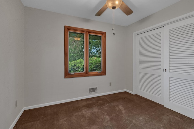 5848 16th Ave SE, Haven Twp, MN 56304 - unfurnished bedroom featuring dark carpet, a closet, and a ceiling fan