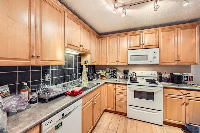 4010 15th Ave S Unit 6D, Minneapolis, MN 55407 - kitchen with white appliances, light wood-style floors, backsplash, light countertops, and a textured ceiling