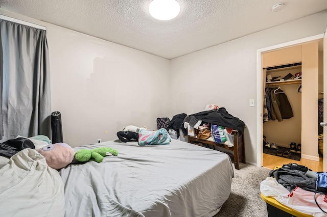 4010 15th Ave S Unit 6D, Minneapolis, MN 55407 - bedroom with a textured ceiling, a walk in closet, and a closet