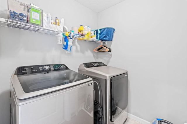 14811 Willemite St NW, Ramsey, MN 55303 - washroom featuring washing machine and clothes dryer and tile patterned flooring