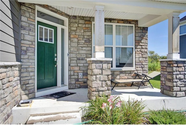 14385 Annapolis Ln N, Dayton, MN 55327 - doorway to property with covered porch and stone siding