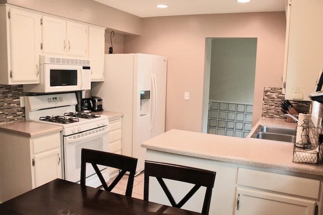 16660 Garland Way W, Lakeville, MN 55068 - kitchen with white appliances, backsplash, recessed lighting, a peninsula, and white cabinets