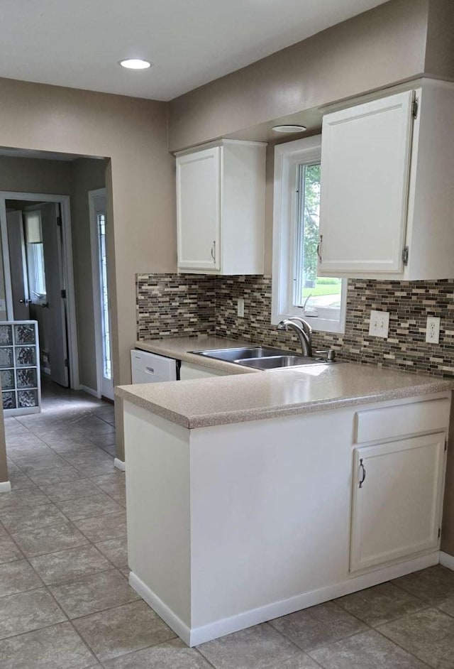 16660 Garland Way W, Lakeville, MN 55068 - kitchen featuring white cabinetry, backsplash, a peninsula, light countertops, and recessed lighting