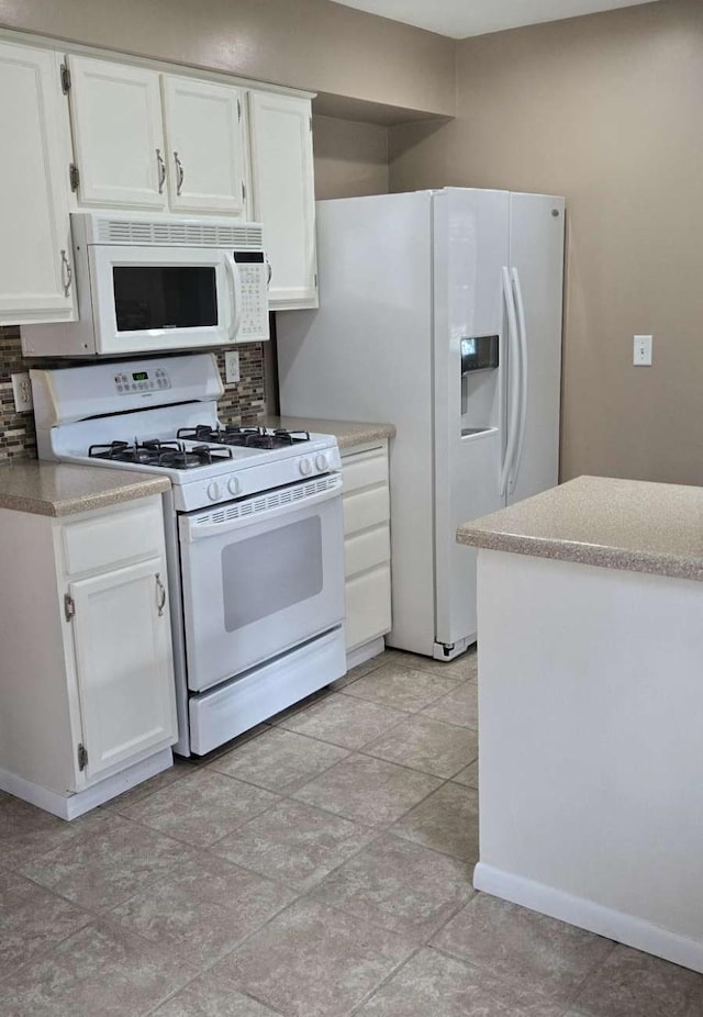 16660 Garland Way W, Lakeville, MN 55068 - kitchen with white appliances, decorative backsplash, white cabinetry, and light countertops