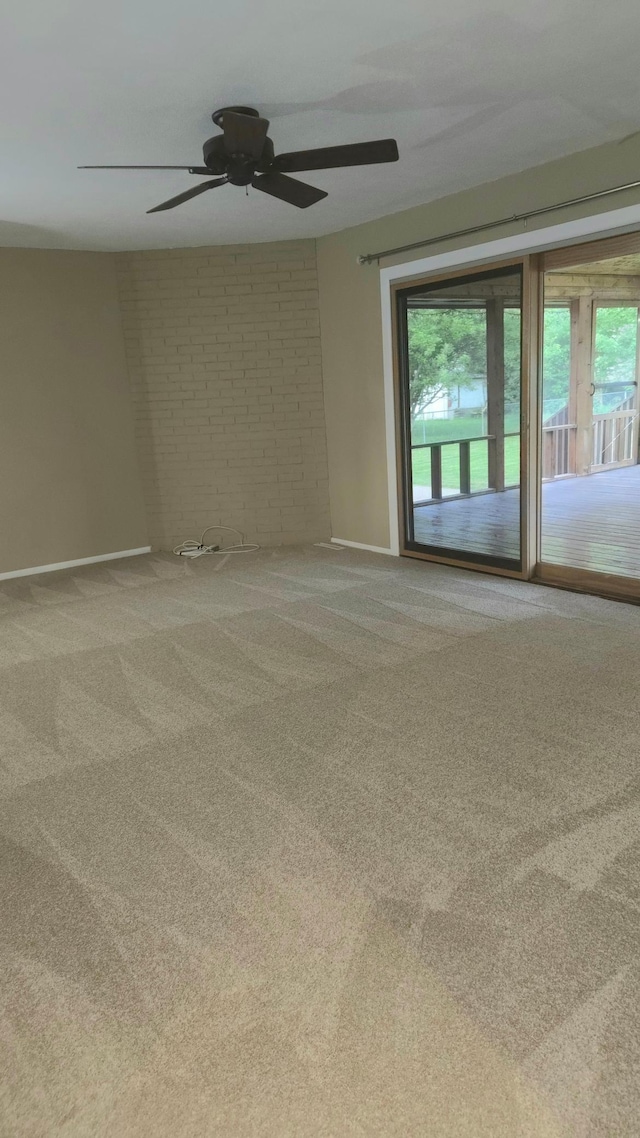 16660 Garland Way W, Lakeville, MN 55068 - carpeted spare room with plenty of natural light, a ceiling fan, and brick wall