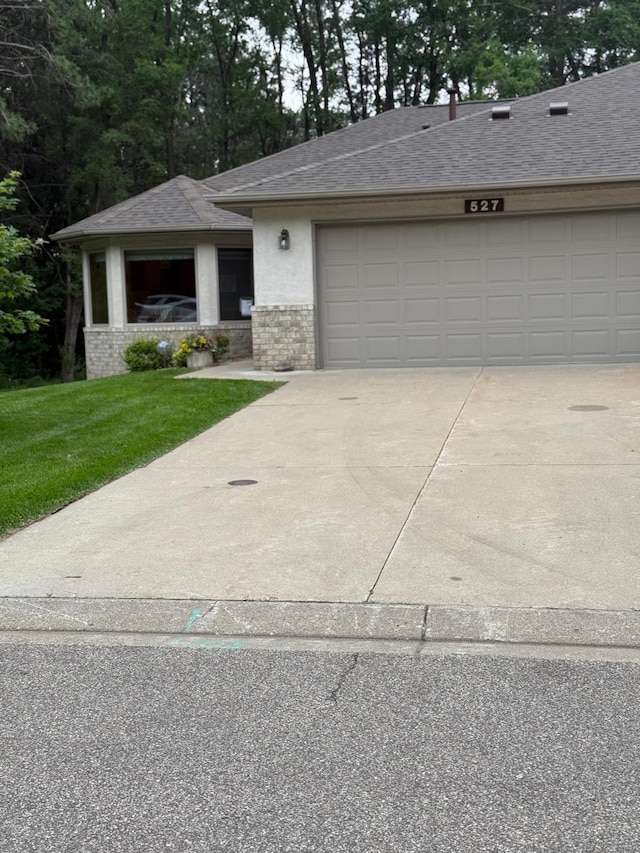 527 Woodside Ct, Shakopee, MN 55379 - view of front of house with concrete driveway, roof with shingles, a front yard, a garage, and brick siding